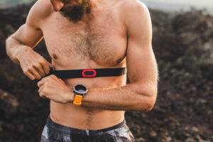 Athlete runner wearing chest heart rate monitor