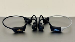 H2O Audio TRI 2 PRO and TRI Run bone conduction headphones side by side on a bench.